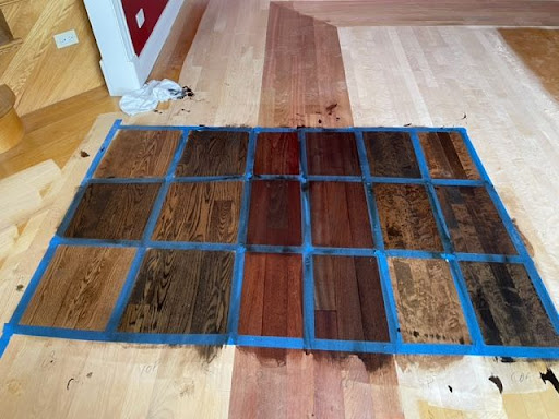 an interior designer selects stain colors for a floor