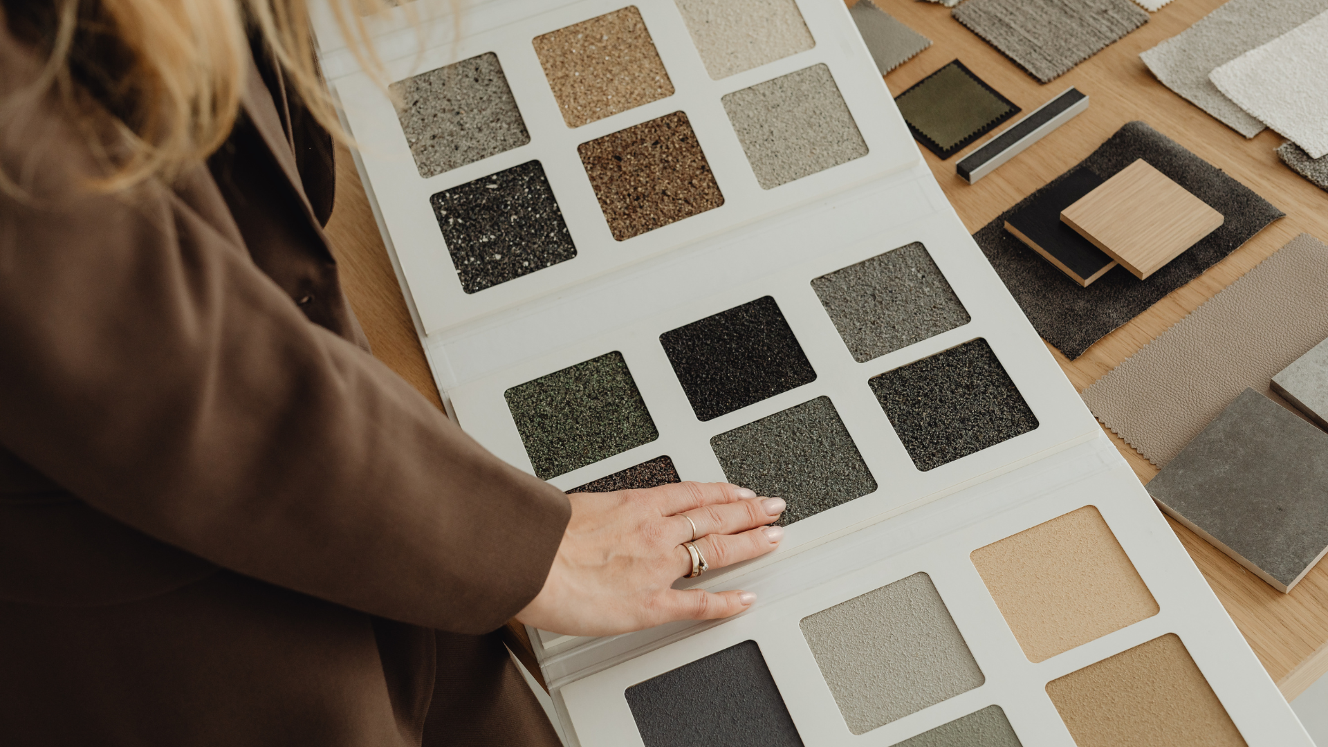 Interior designer choosing warm and neutral fabrics from a swatch