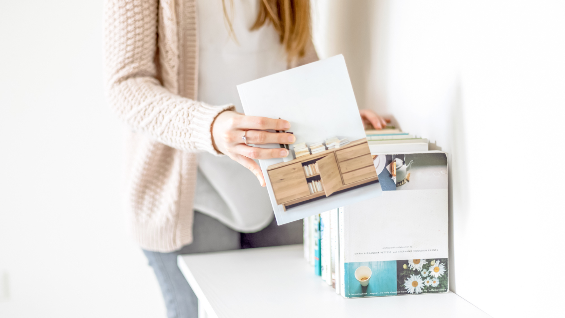 Female Interior designer in a pastel blazer organizing design references